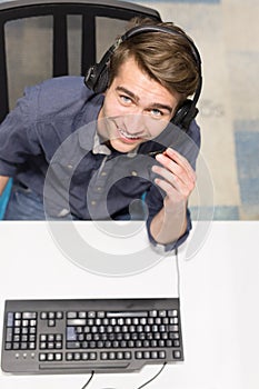 Male call centre operator doing his job top view