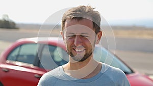 Male car tourist stopped to unwind and enjoy fresh sea breeze and freedom