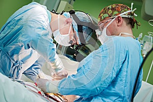 Male cardiac surgeon at child cardiosurgery operating room photo