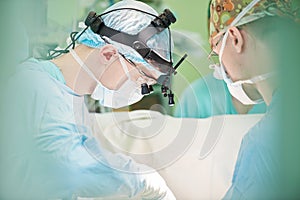 Male cardiac surgeon at child cardiosurgery operating room photo