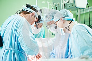 Male cardiac surgeon at child cardiosurgery operating room photo
