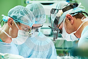 Male cardiac surgeon at child cardiosurgery operating room photo