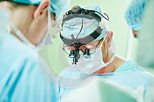 Male cardiac surgeon at child cardiosurgery operating room photo