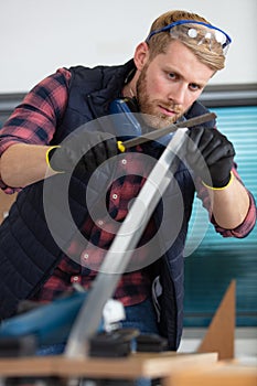 male carpenter making furniture in workshop