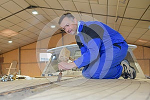 Male carpenter using hammer and chisel