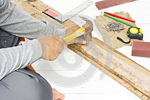 Male carpenter using hammer and nail at work place.Background craftsman tool