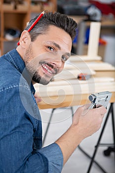 male carpenter using staple gun