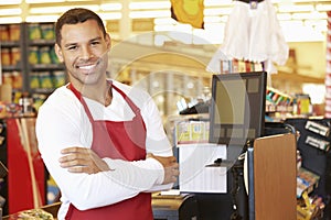 Male Cashier At Supermarket Checkout