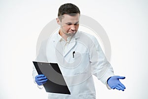 A male caucasian doctor in a white lab coat and blue disposable medical gloves