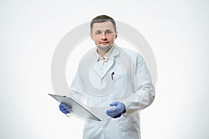 A male caucasian doctor in a white lab coat and blue disposable medical gloves