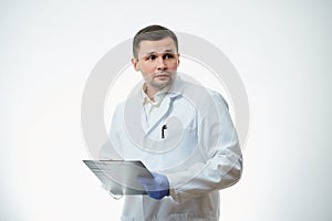 A male caucasian doctor in a white lab coat and blue disposable medical gloves