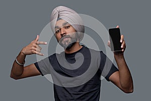 Male with the cellphone showing the hand sign