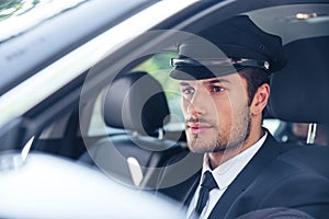 Male chauffeur sitting in a car