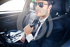 Male chauffeur sitting in a car