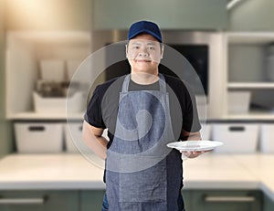 Male Chef assistant holding White plate