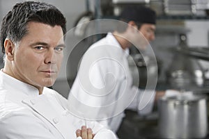 Male Chef With Colleague In Kitchen photo