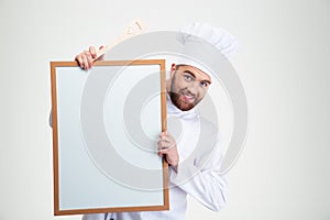 Male chef cook holding blank board