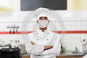 Male chef in face mask at restaurant kitchen