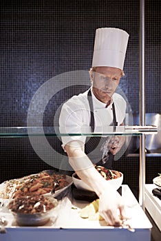 Male, chef and food in kitchen of restaurant for catering industry for meal with hospitality or fine dining with