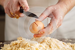 Male chef prepares. Man mixes whisk eggs. Top view