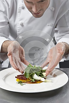 Male Chef Preparing Salad In Kitchen