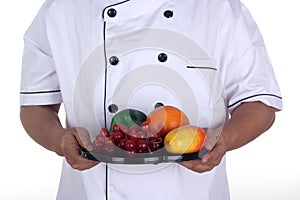 The male chef present healthy fruit