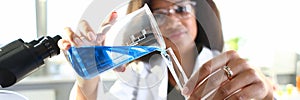 A male chemist holds test tube of glass