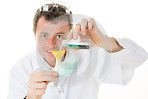 Male chemist holds test tube of glass in his hand overflows a liquid