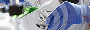 A male chemist holds test tube of glass in his hand