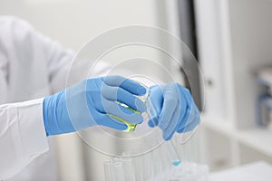 A male chemist holds test tube of glass