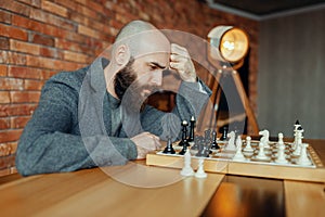 Male chess player playing, thinking process