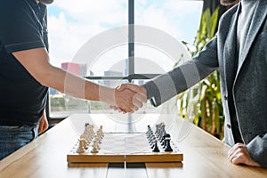 Male chess players shake hands before the game