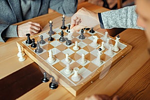 Male chess players, white knight takes pawn