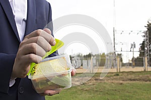 Male chief engineer snacks in the workplace, energy, proper nutrition, copy space, close-up, outdoor