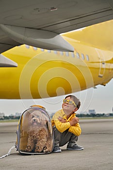 Male child and his pet at the airdrome