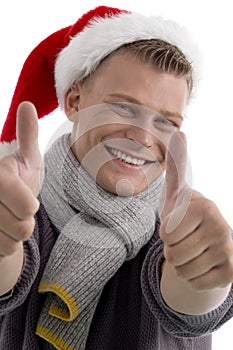 Male with christmas hat showing thumb up