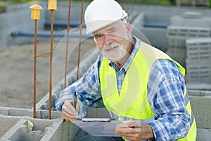 male civil engineer checking projects on construction site