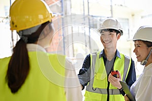 Male civil engineer having a conversation with his construction inspector and architect