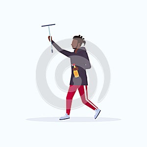 Male cleaner holding shower wiper squeegee and spray plastic bottle african american casual man wiping glass cleaning