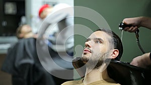 Male client getting head washed at the barbershop