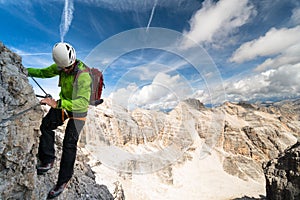 Male climber on an exposed Via Ferrata in the Dolomites