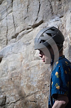 Male climber with helmet looking to left