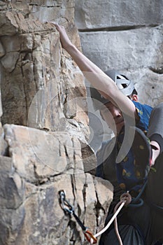 Male climber positioning foot on climb