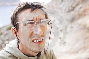 Male climber wearing belay glasses while watching his partner climbing photo