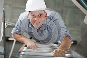 male climbs ladder storage cold tank