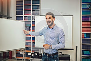 Male coach giving presentation for audience in lecture hall