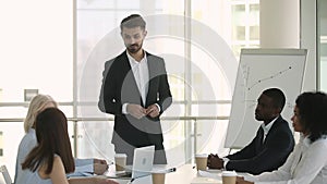 Male coach in suit asking questions talking interacting with employees