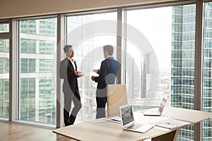 Male colleagues taking coffee-break in office