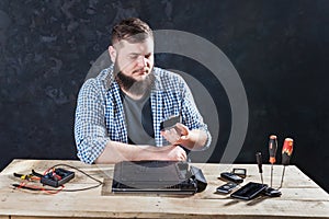 Male computer engineer fixing problem with laptop