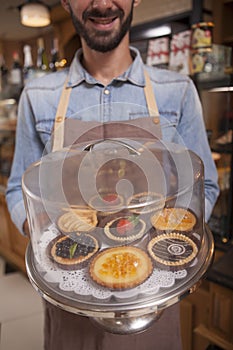 Male confectioner working at his cafe